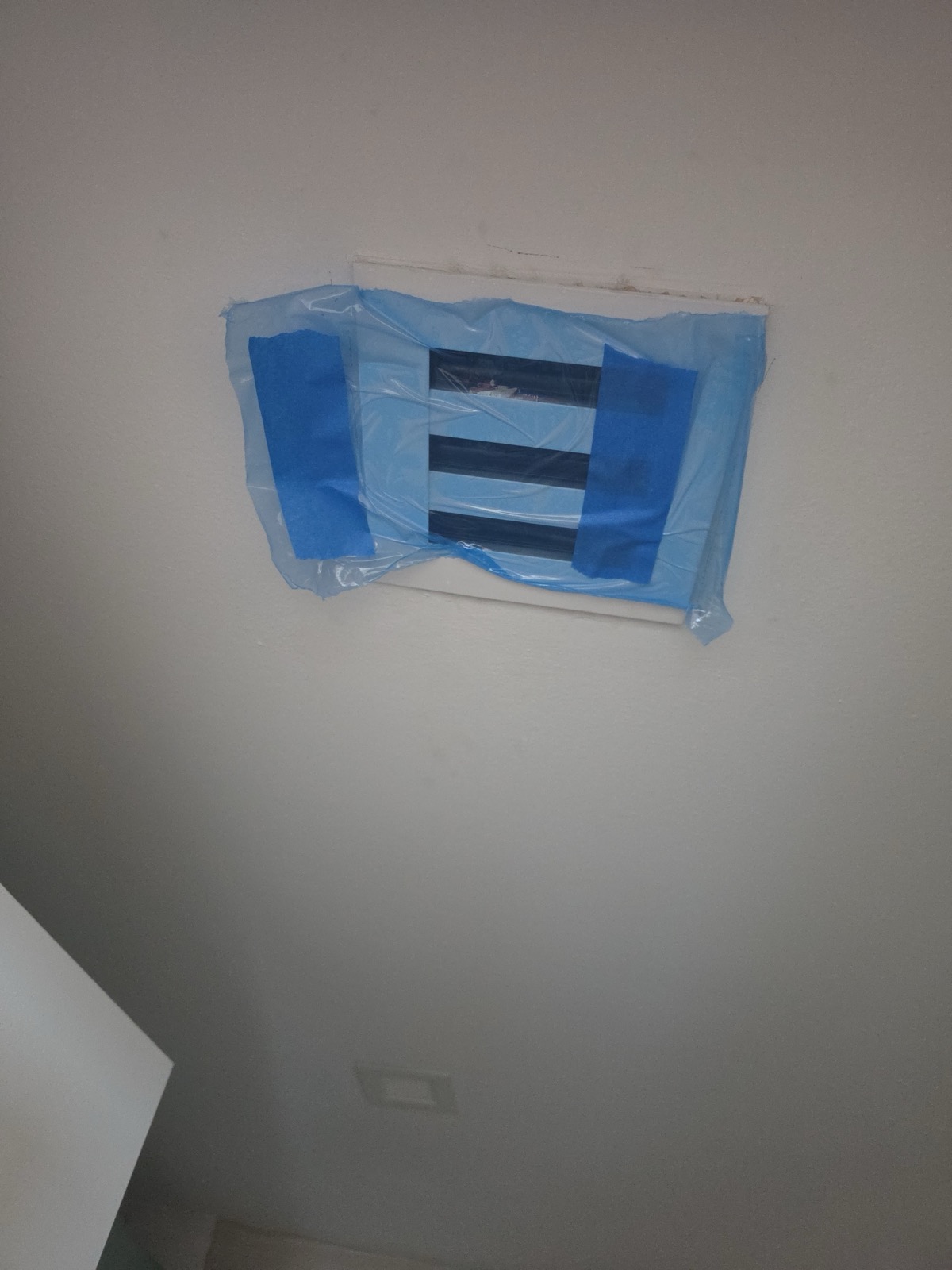 Supply registers covered and prepared before a duct cleaning in a Miami home
